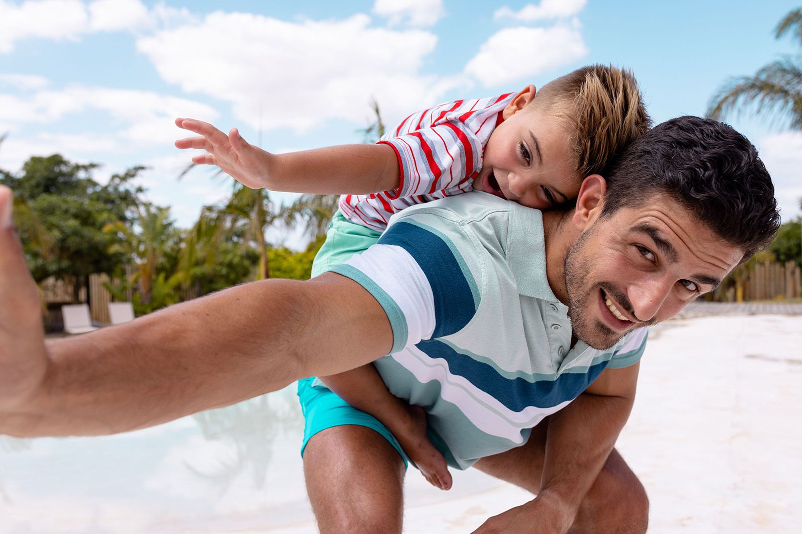 Happy father and child playing on the beach for father's day.