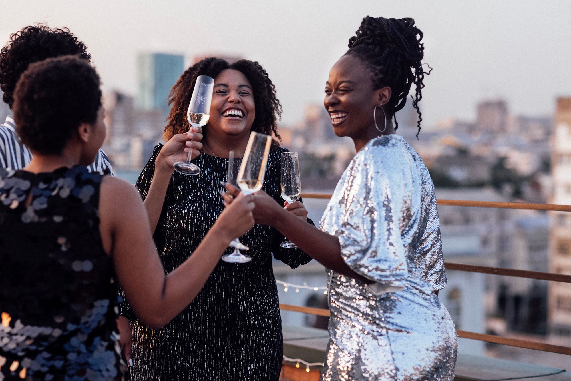 African American women toasting on a rooftop patio in Miami while celebrating Juneteenth.
